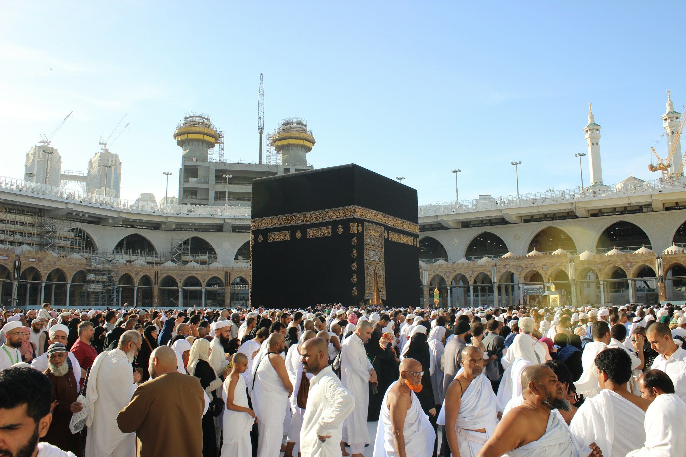 A dense crowd of pilgrims around the Kaaba in the Masjid al-Haram courtyard